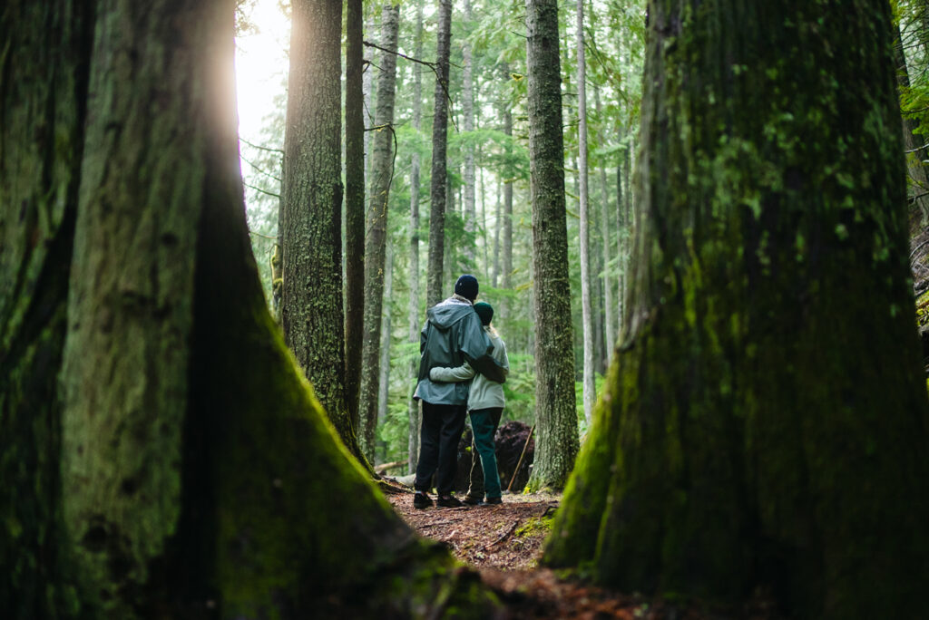 A couple hugs in the woods after hiking and vaping cannabis